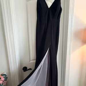 Xscape Black Asymmetrical Dress with White Accent and rhinestones.